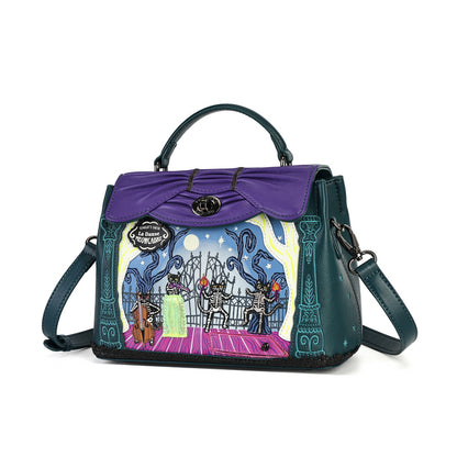 A Disney-themed handbag featuring a purple top flap with a gold-tone logo clasp, dark teal leather sides and handles, and a colorful illustrated front panel depicting skeleton horses and a moonlit scene. The bag is shown on a plain white background with its top handle raised and a shoulder strap visible.