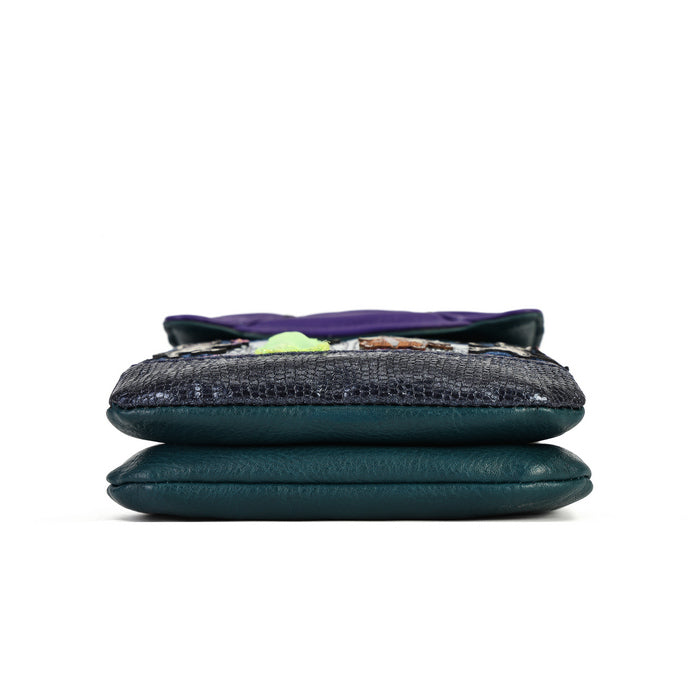 A folded dark teal leather clutch or wallet with a textured black snakeskin pattern panel on the front, set against a plain white background.
