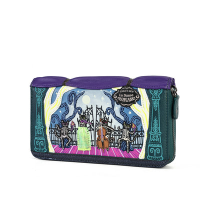 A Disney La Belle Reclusa zip-around clutch wallet featuring a colorful gothic illustration of skeleton dancers, purple leather trim, and a dark teal body, shown on a plain white background.