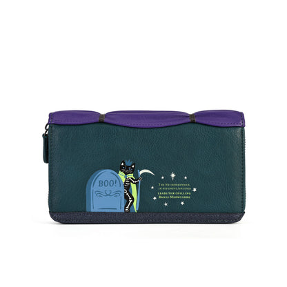 A dark teal pebbled leather zip-around wallet featuring a Halloween-themed graphic of a cat standing on a tombstone with the text 'BOO!' and 'The Funniest Winter Story in Library History' by Julia Warhorn.