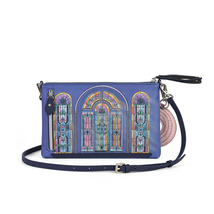 A blue crossbody bag featuring a colorful stained glass window design on the front, with a navy blue strap and a pink circular charm.