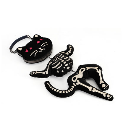 A black gothic-style plush accessory set featuring a cat-shaped pouch with pink details and a skeleton cat figure with matching skeleton chain details, shown on a plain white background.