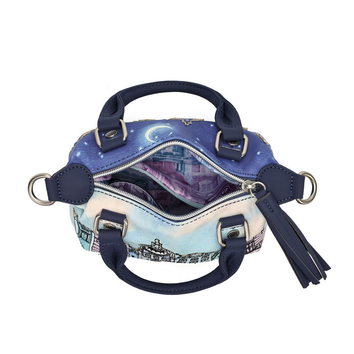 An open satchel handbag with navy blue leather handles and trim, featuring a printed celestial night sky design in blue, purple, and white on the exterior, with a tassel charm and silver-tone hardware on a plain white background.