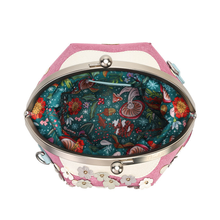 A novelty house-shaped crossbody with a secure clasp, detachable strap and compact main compartment. Printed and embossed vegan leather turns snowy toadstool houses, fairy doors, winter trees, rabbits and snowflakes into a playful winter woodland design.
