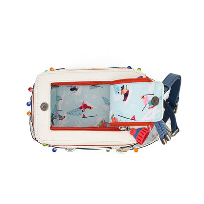 A top-down view of a white crossbody bag with colorful decorative beads along the edges, featuring a light blue patterned interior with cartoon characters and a matching zippered card holder. A blue strap is visible on the right side.