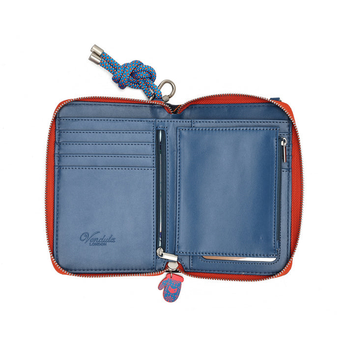 compact organiser with a front phone pocket, ziparound compartment, multiple internal pockets, mirror and detachable crossbody strap. Embroidery and appliqué add texture to artwork featuring snowy peaks, chalet scenes, gondolas and ski-route details.