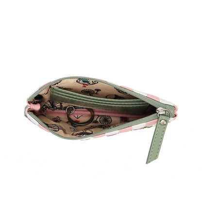 An open zippered coin purse with a pink and white patterned exterior, a sage green interior lining, and a bicycle print on the inside flap, shown on a white background.
