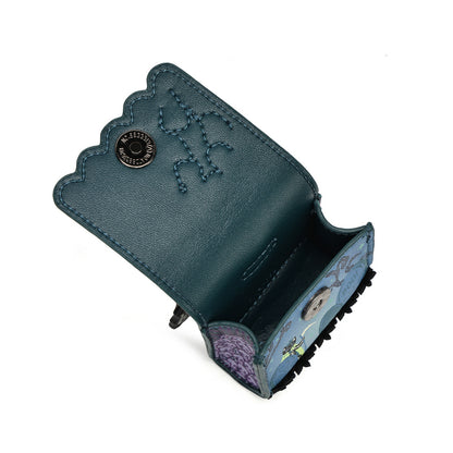A dark teal leather accessory case shown open, featuring scalloped edges, a snap button closure, decorative stitching, and a printed blue-and-purple pattern on the interior base.