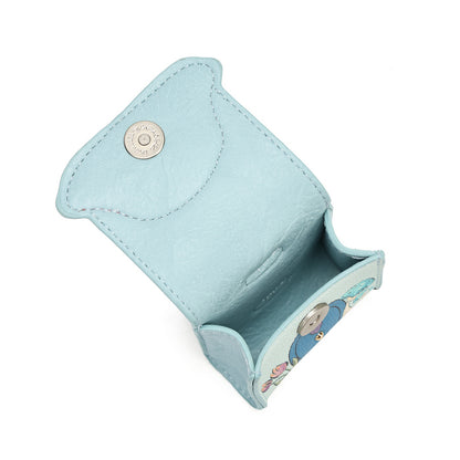 A light blue leather card holder or coin purse shown open, featuring a silver snap button closure and a small embroidered character detail on the lower edge, set against a plain white background.