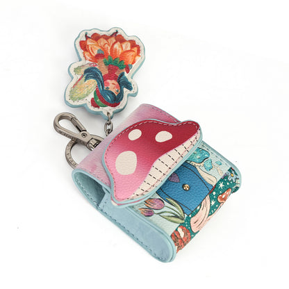 A small multicolor patchwork wallet with a mushroom-shaped flap and a matching flower-shaped keychain, shown on a plain white background.