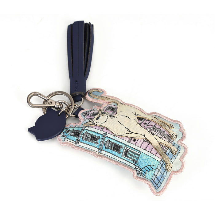 A fashion accessory keychain featuring a pastel embroidered illustration of a horse and a vintage tram, attached to a navy blue leather tassel and a silver-tone metal keyring.