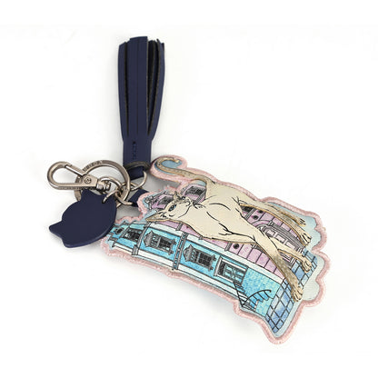 A fashion accessory keychain featuring a pastel embroidered illustration of a horse and a vintage tram, attached to a navy blue leather tassel and a silver-tone metal keyring.