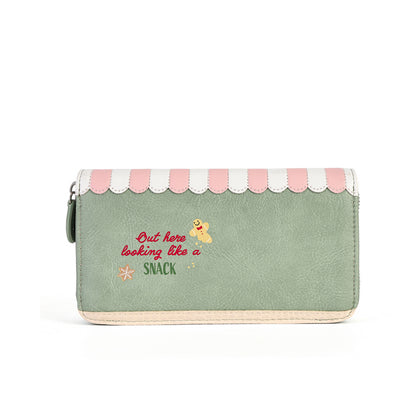 A mint green faux leather zip-around wallet with a pink and white scalloped awning design on top, featuring the text 'Out here looking like a snack' in red and yellow embroidered lettering.