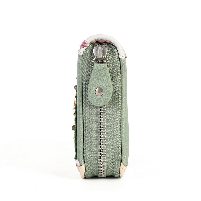 A sage green textured leather zippered pouch with a snap tab closure and silver metal hardware, shown from a side profile view on a white background.