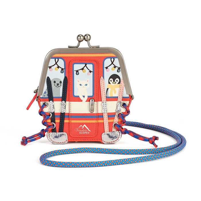 A Slopes brand kiss-lock clutch bag designed to look like a retro orange and cream bus with cat illustrations in the windows, featuring a blue and orange patterned shoulder strap.