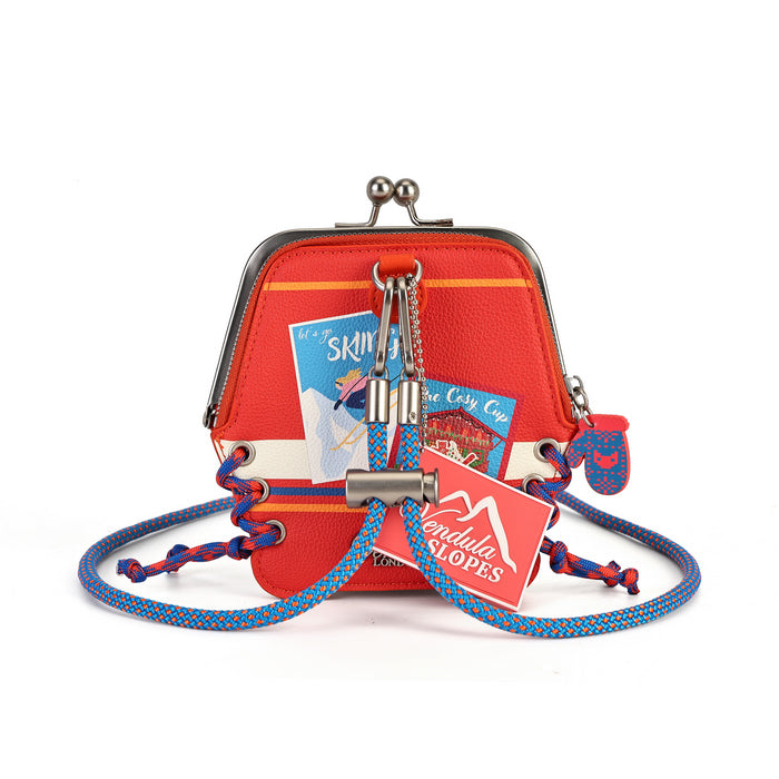 A red kiss-lock purse with a blue and red braided shoulder strap, featuring a metal padlock and keychain charm with a red 'Pendleton Peaks' tag, and a small travel photo tucked inside, set against a plain white background.