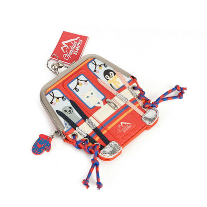A small Louis Vuitton coin purse designed to look like a red and orange Christmas van, featuring penguin and snowman illustrations, red and blue braided tassels, and a small matching mittens charm.