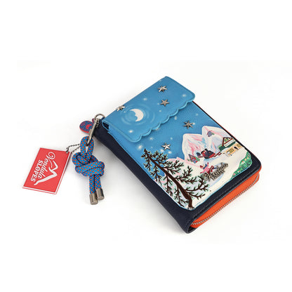 compact organiser with a front phone pocket, ziparound compartment, multiple internal pockets, mirror and detachable crossbody strap. Embroidery and appliqué add texture to artwork featuring snowy peaks, chalet scenes, gondolas and ski-route details.
