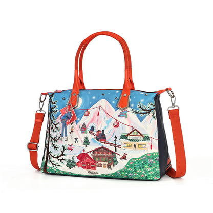 A colorful winter mountain ski resort handbag with red handles and an adjustable red shoulder strap, featuring a printed scenic alpine illustration on a white background.
