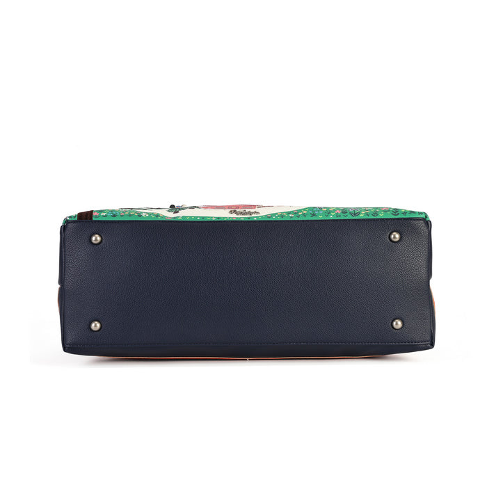 The bottom view of a handbag showing a dark navy blue pebbled leather base with silver metal studs, and a green and white patterned fabric lining visible along the top edge.