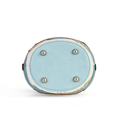 A novelty house-shaped crossbody with a secure clasp, detachable strap and compact main compartment. Printed and embossed vegan leather turns snowy toadstool houses, fairy doors, winter trees, rabbits and snowflakes into a playful winter woodland design.
