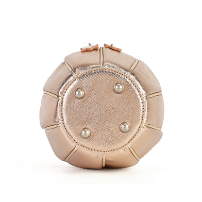 A round, dome-shaped metallic champagne clutch bag with a textured center panel, four silver pearl studs, and a top zipper closure, shown on a plain white background.