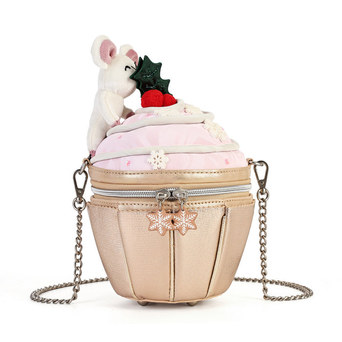 A novelty purse designed to look like a frosted dessert, featuring a metallic champagne-gold textured body, a light pink top layer, a plush white mouse, and red berries on top. It has a silver chain strap and snowflake charms.
