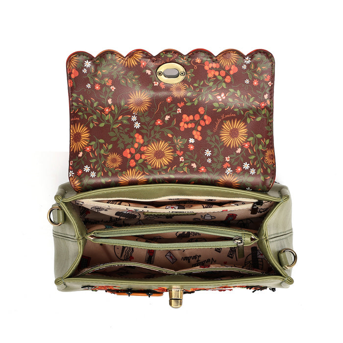 An open handbag shown from above on a white background, featuring a brown floral-patterned exterior with a scalloped top edge, olive green sides, and a patterned interior with zip compartments.