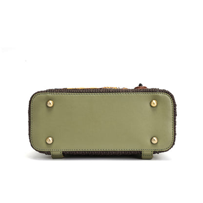 The bottom view of a Louis Vuitton shoulder bag in olive green leather with gold-tone studs and a dark brown fringed trim, shown on a white background.