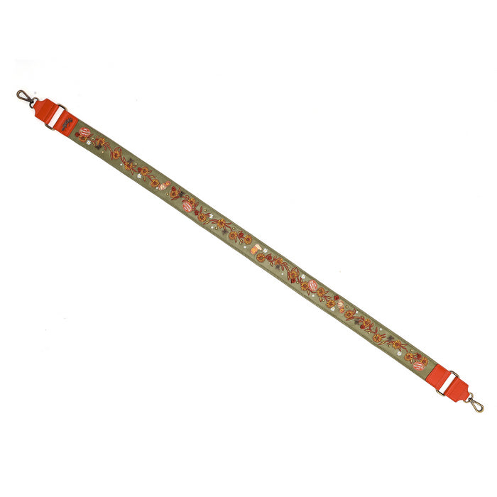 A long decorative strap with a light olive green base, covered in a repeating pattern of small red, orange, and gold floral motifs, featuring bright red plastic hardware and clips on both ends, shown on a plain white background.