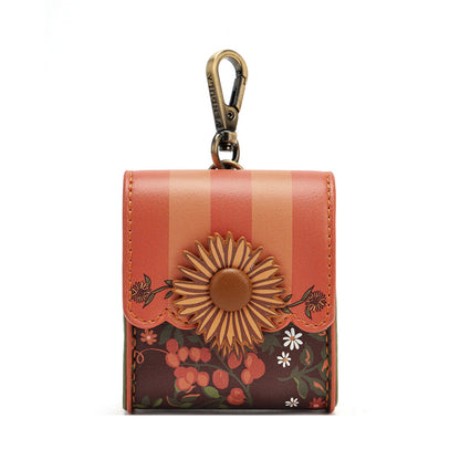 A small leather key pouch with a floral and striped design, featuring a large embossed sunflower on the front and a brass key clasp at the top, shown against a plain white background.