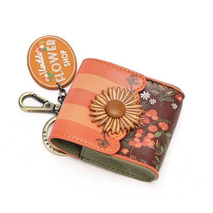 A floral leather wallet keychain with a large daisy flower embellishment and a silver clasp, shown on a white background with a 'Madly's Flower Shop' tag.