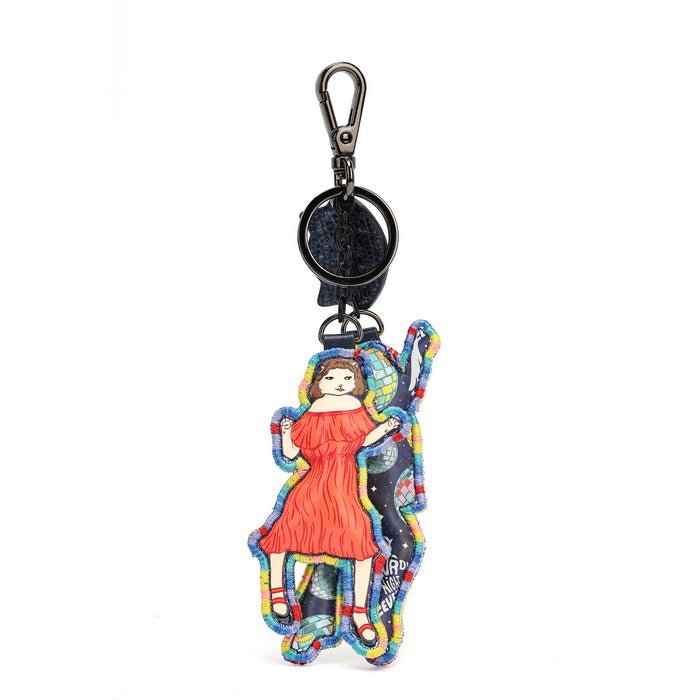 A colorful embroidered keychain featuring a cartoon-style girl in a red dress, attached to a black plastic swivel clasp and ring on a white background.