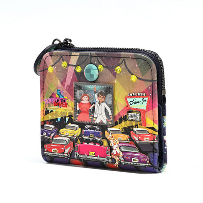 A zip-around clutch bag featuring a vibrant, colorful retro 1960s and 1970s New York City scene with classic cars, a disco ball, and a movie theater screen, shown on a plain white background.