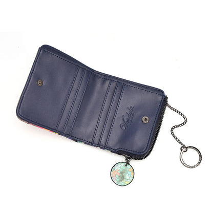 A navy blue leather wallet shown open, featuring multiple card slots, a zipper closure, a silver-tone chain, and a round iridescent disco ball charm.