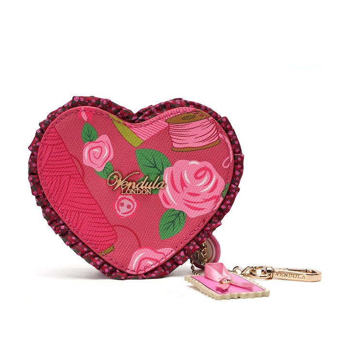 A heart-shaped pink fabric pouch with embroidered roses, green leaves, and a pink spool motif, featuring a dark pink beaded border and a gold-tone keychain with a pink bow charm.