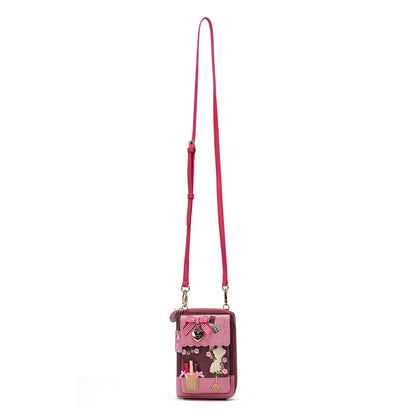 A pink crossbody phone bag with a long strap, featuring a cartoon bunny design and small decorative charms on a plain white background.