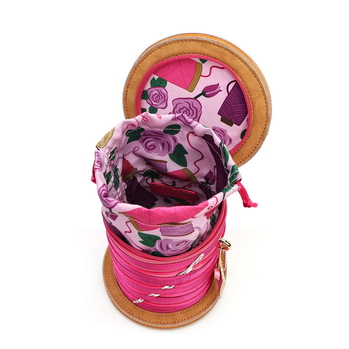 A pink and purple floral drawstring storage bag with a tan leather-like rim, shown open on a white background.