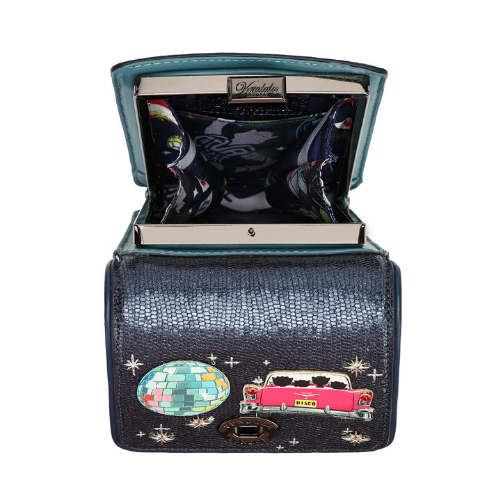 An open black crocodile-embossed clutch wallet by Dolce & Gabbana, featuring a turquoise interior lining, a colorful disco ball patch, and a pink classic car patch on a white background.