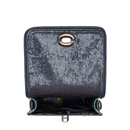 A dark gray textured faux-leather handbag shown open, featuring a silver-tone oval metal ring closure on the front flap and a colorful patterned interior lining.