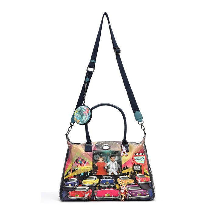 A colorful handbag with a black strap and handle, decorated with a vibrant illustration of classic cars, a couple, and retro street signs, shown on a plain white background.