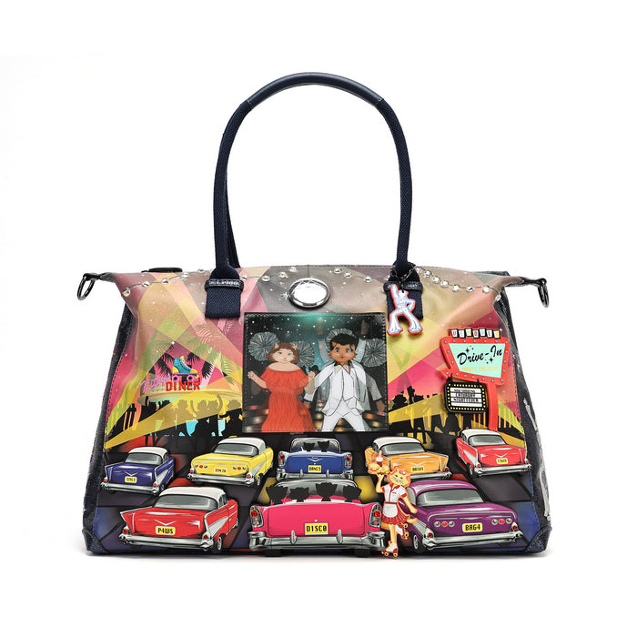 A structured handbag with a colorful retro-themed graphic print featuring vintage cars, a couple, and a disco ball, complete with black double shoulder straps and a hanging plush charm.