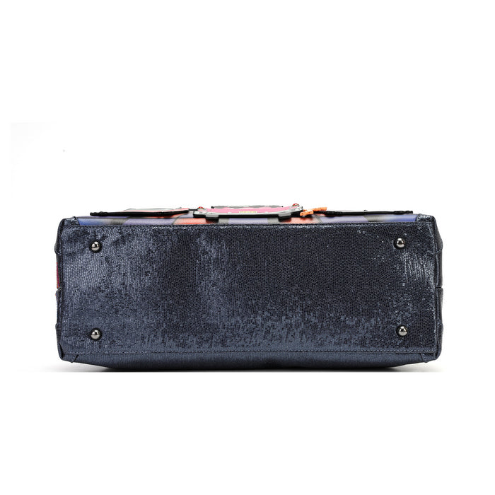 A dark navy blue velvet rectangular clutch bag shown from the back, featuring a textured velvet finish, silver metal studs, and a colorful patterned lining visible along the top edge, set against a plain white background.