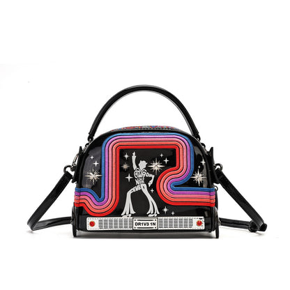 A black dome-shaped handbag with a retro 1970s design, featuring a colorful neon arch pattern in pink, purple, blue, and red, alongside a white disco ball and star graphics. The bag has a black top handle, a matching shoulder strap, and a front label that reads 'DRY VOGUE'.