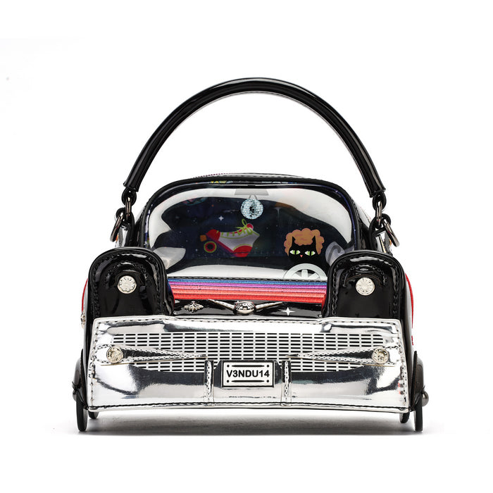 A miniature handbag designed in the shape of a classic car, featuring a glossy black body, a shiny chrome silver front grille, and a clear windshield showing colorful cartoon characters inside. It has a black handle and a license plate reading 'VENDU14'.