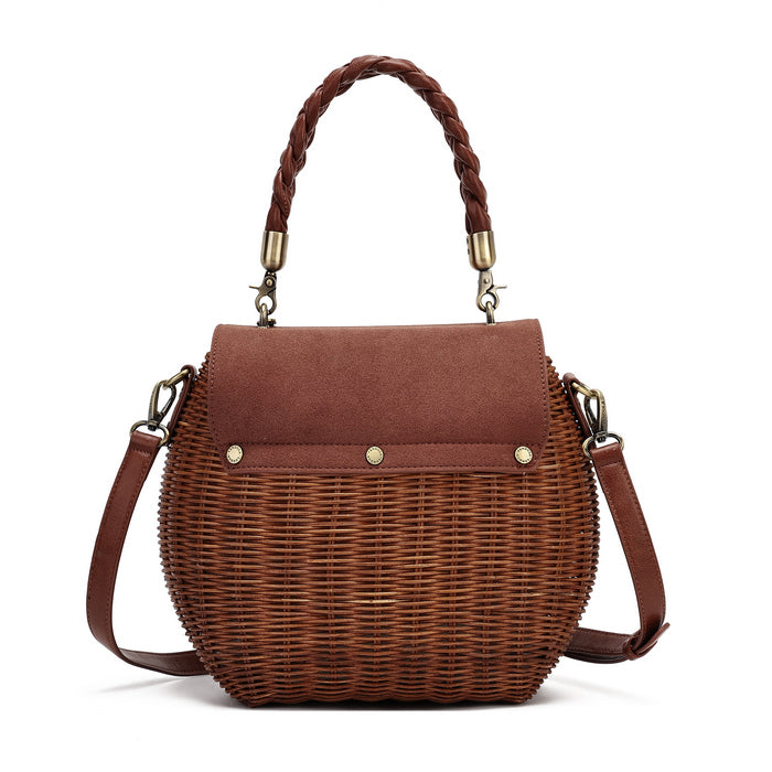 A brown wicker handbag with a suede top flap, braided top handle, and a detachable shoulder strap, shown on a plain white background.