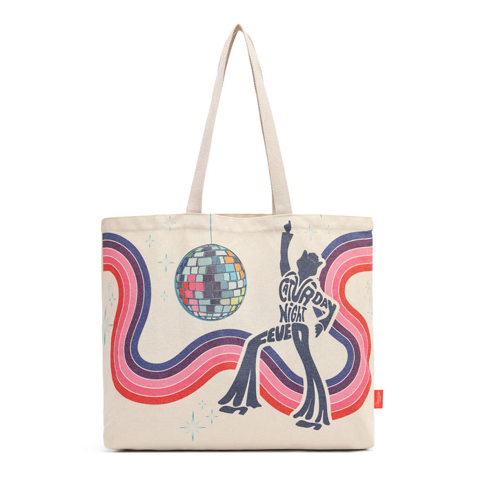 A canvas tote bag with a retro 1970s disco theme, featuring a dancing silhouette, a disco ball, and wavy pink, purple, and red lines on a cream background. The bag has two cream-colored shoulder straps and a small red tag on the right side.