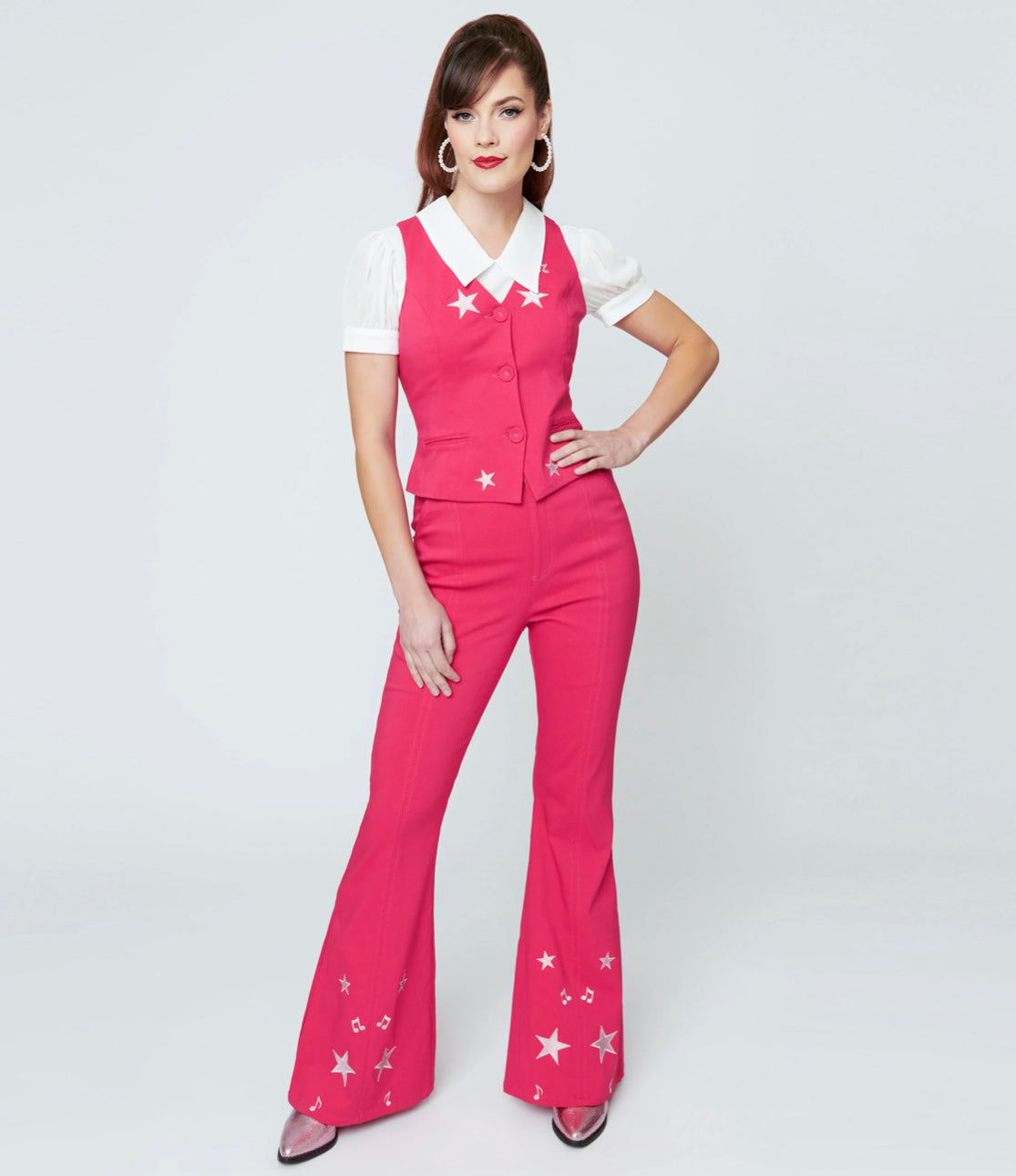 These sensational 1970s style bell bottoms are crafted in a bright pink bengaline stretch with contrast seaming and glittery stars on the flare legs. The banded high waist is cinched with a front zipper and button, outfitted with side and back pockets for modern function!