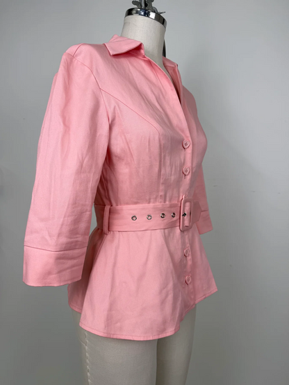A pink women's blazer-style jacket with a collar, three-quarter sleeves, front buttons, and a matching waist belt with metal eyelets, displayed on a dress form against a plain light gray background.