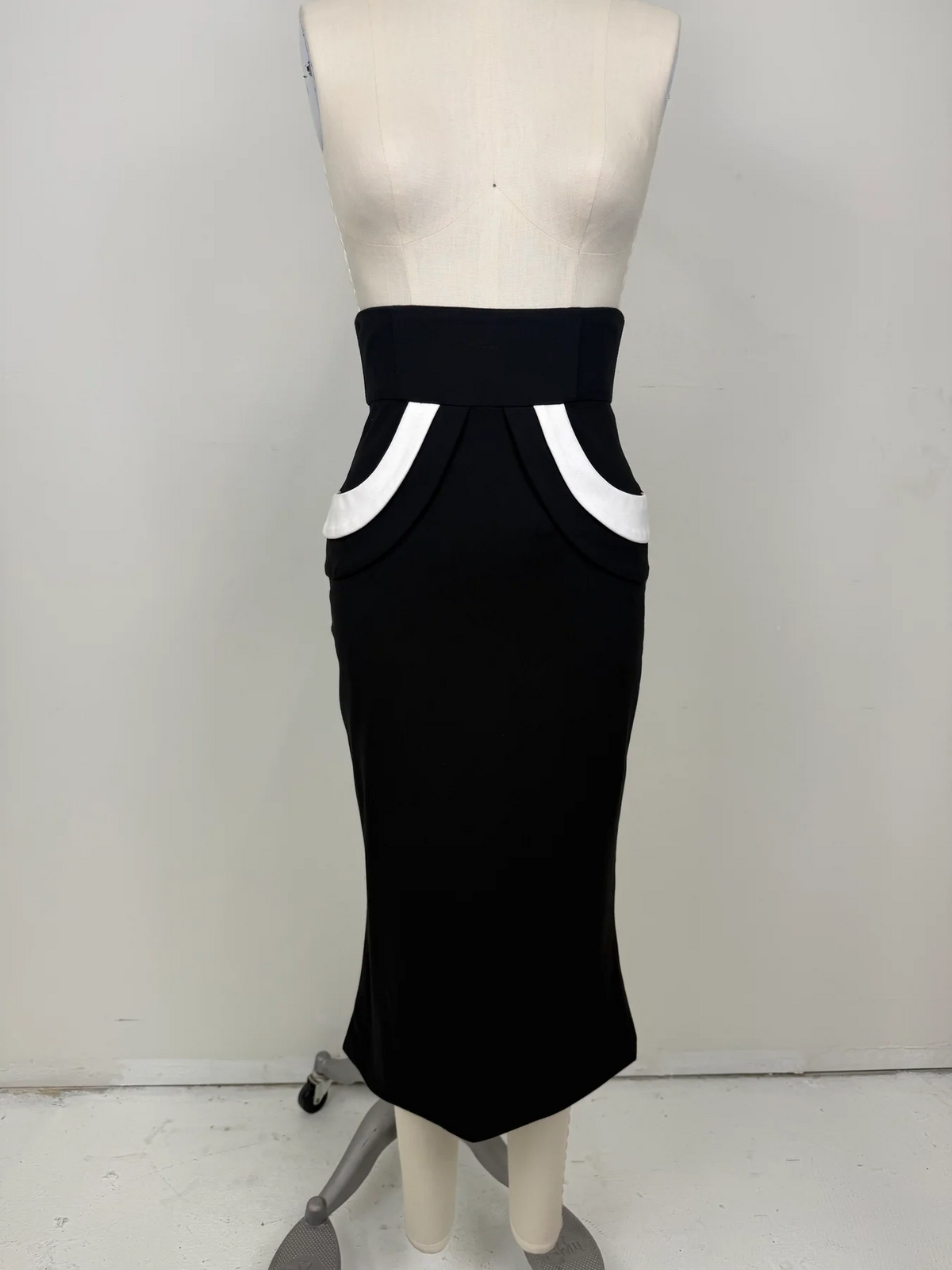 The Love Me Not Skirt is designed with a sleek, high waisted silhouette that flatters the figure while keeping the look polished and refined.